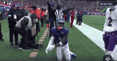 A Football Player With The Number 2 On His Jersey Kneeling Down On The Field GIF