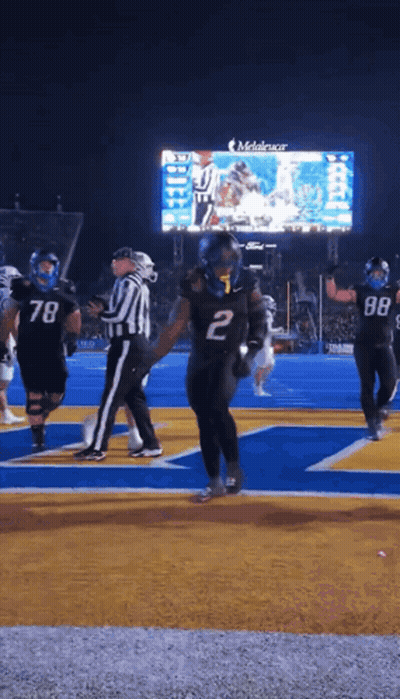 A Football Player With The Number 2 On His Jersey Stands On The Field GIF