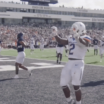 A Football Player With The Number 2 On His Jersey Stands On The Field GIF