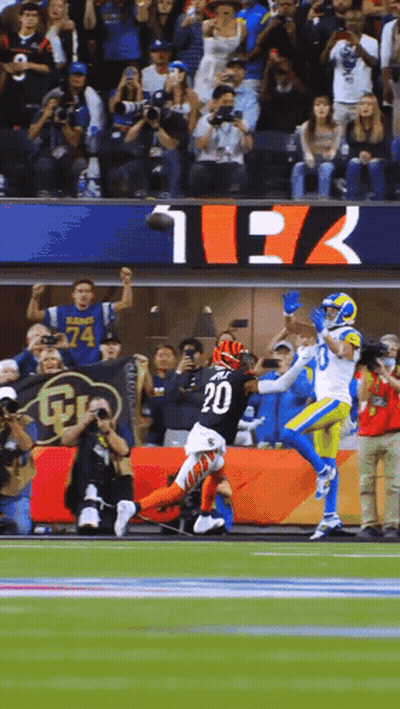 A Football Player With The Number 20 On His Jersey Catches A Pass GIF