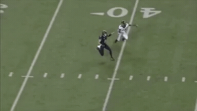 A Football Player With The Number 20 On His Jersey Is Catching A Ball GIF