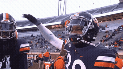 A Football Player With The Number 20 On His Jersey Stands In A Stadium GIF