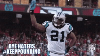 A Football Player With The Number 21 On His Jersey Is Waving His Hand . GIF