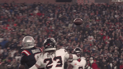 A Football Player With The Number 22 On His Jersey Catches The Ball GIF