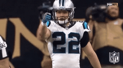 A Football Player With The Number 22 On His Jersey Is Giving A Thumbs Up During A Game . GIF