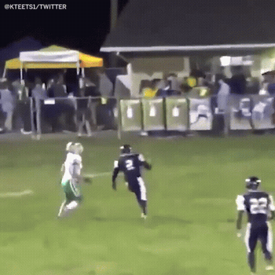 A Football Player With The Number 22 On His Jersey Is Running On The Field GIF
