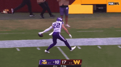 A Football Player With The Number 22 On His Jersey Is Running On The Field GIF