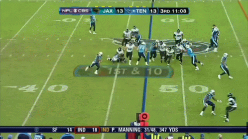 A Football Player With The Number 22 On His Jersey Is Running With The Ball GIF