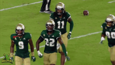 A Football Player With The Number 22 On His Jersey Is Surrounded By Other Players GIF