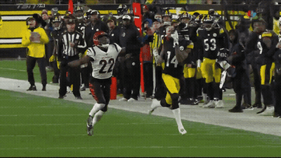 A Football Player With The Number 22 On His Jersey Runs On The Field GIF