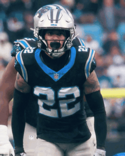 A Football Player With The Number 22 On His Jersey Stands On The Field GIF