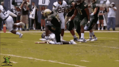 A Football Player With The Number 23 On His Jersey Is Kneeling On The Field GIF