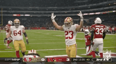 A Football Player With The Number 23 On His Jersey Stands On The Field GIF