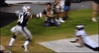A Football Player With The Number 24 On His Jersey Is Running Towards Another Player GIF
