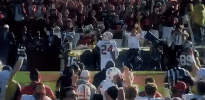 A Football Player With The Number 24 On His Jersey Is Surrounded By Fans GIF