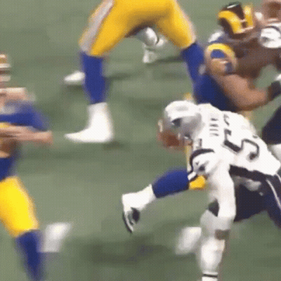 A Football Player With The Number 25 On His Jersey Is Being Tackled By Another Player GIF