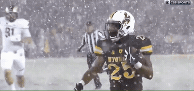 A Football Player With The Number 25 On His Jersey Runs In The Snow GIF