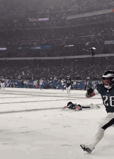 A Football Player With The Number 26 On His Jersey Is Running On A Snowy Field GIF