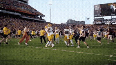 A Football Player With The Number 26 On His Jersey Is Running On The Field GIF