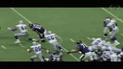A Football Player With The Number 26 On His Jersey Is Running With The Ball GIF