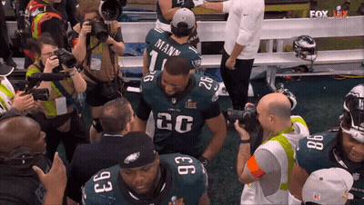 A Football Player With The Number 26 On His Jersey Is Surrounded By Other Players GIF