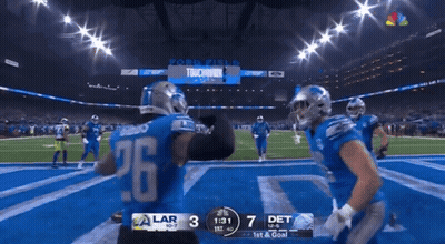 A Football Player With The Number 26 On His Jersey Stands On The Field GIF