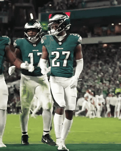 A Football Player With The Number 27 On His Jersey Stands On The Field GIF