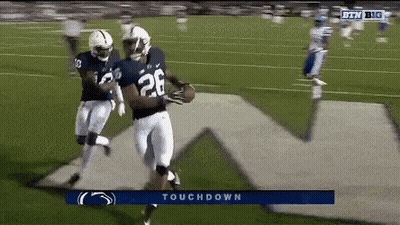 A Football Player With The Number 28 On His Jersey Is Running On A Field GIF