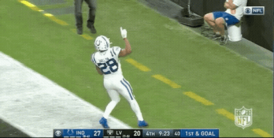 A Football Player With The Number 28 On His Jersey Stands On The Field GIF