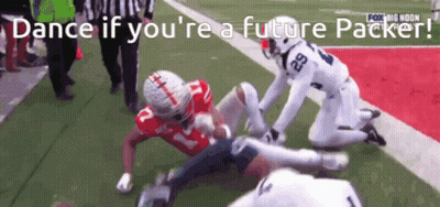A Football Player With The Number 29 On His Jersey Is Being Tackled By Another Player GIF