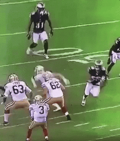 A Football Player With The Number 3 On His Jersey Is Being Tackled By Another Player GIF