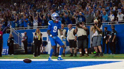 A Football Player With The Number 3 On His Jersey Is Celebrating A Touchdown . GIF