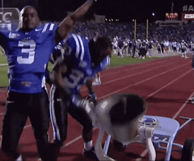 A Football Player With The Number 3 On His Jersey Stands On A Track GIF