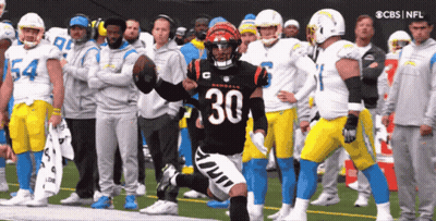 A Football Player With The Number 30 On His Jersey Is Running On The Field GIF
