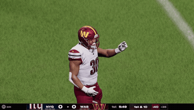 A Football Player With The Number 30 On His Jersey Stands On A Field GIF