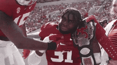 A Football Player With The Number 31 On His Jersey Is Being Helped Off The Field GIF