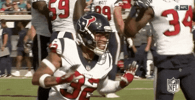 A Football Player With The Number 32 On His Jersey Is Running With The Ball . GIF