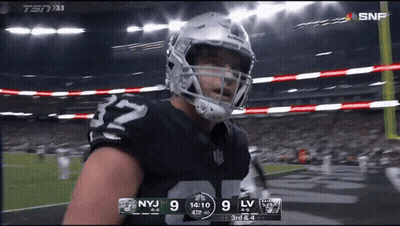 A Football Player With The Number 32 On His Jersey Stands On The Field GIF