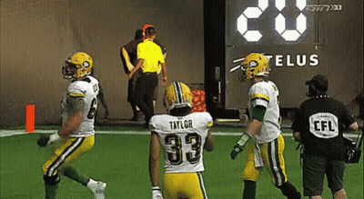 A Football Player With The Number 33 On His Back Is Running On The Field . GIF