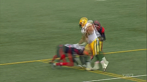 A Football Player With The Number 36 On His Jersey Is Being Tackled GIF