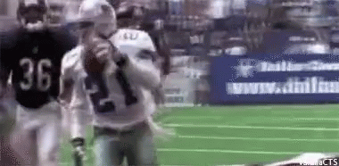 A Football Player With The Number 36 On His Jersey Is Holding A Football GIF