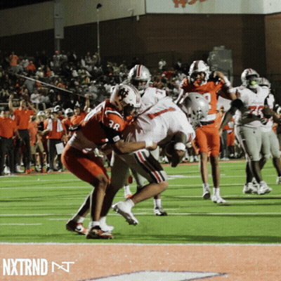 A Football Player With The Number 38 On His Jersey Is Being Tackled By Another Player On The Field GIF