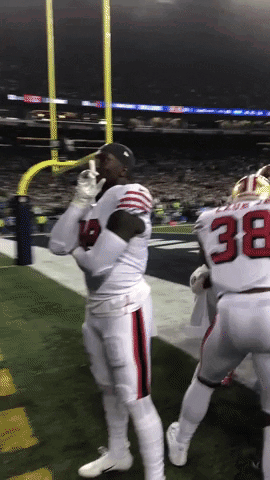 A Football Player With The Number 38 On His Jersey Stands On The Field GIF