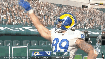 A Football Player With The Number 39 On His Jersey Celebrates A Touchdown GIF