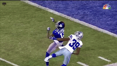 A Football Player With The Number 39 On His Jersey Is Trying To Catch The Ball GIF