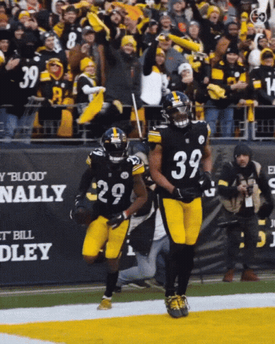 A Football Player With The Number 39 On His Jersey Runs On The Field GIF