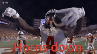 A Football Player With The Number 4 On His Jersey Holds A Football In His Hands GIF