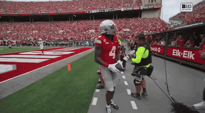 A Football Player With The Number 4 On His Jersey Is Being Interviewed GIF