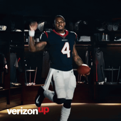 A Football Player With The Number 4 On His Jersey Is Holding A Football GIF