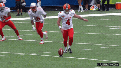 A Football Player With The Number 4 On His Jersey Is Kicking A Ball GIF